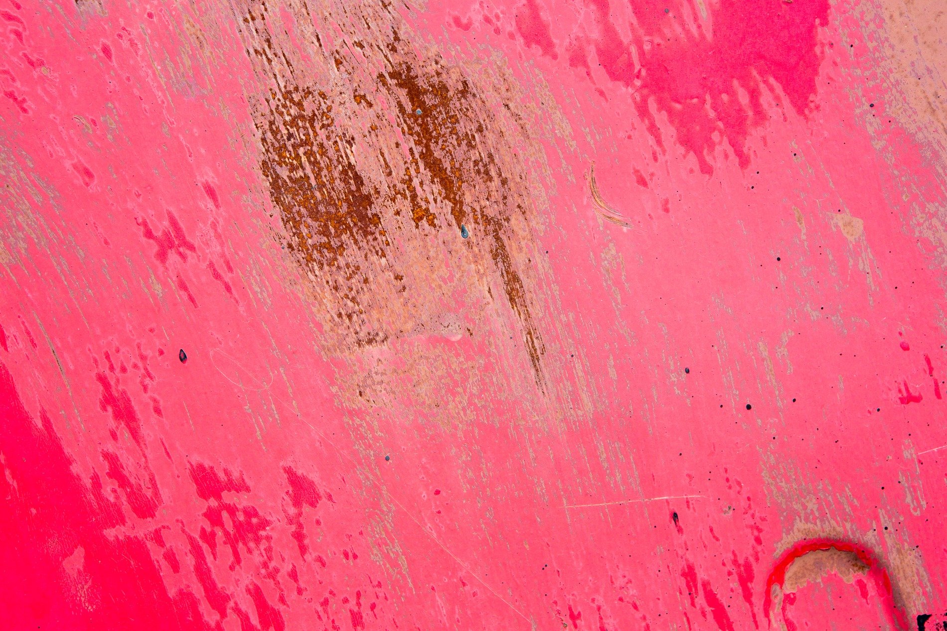 Bright pink starts to fade, rust blooms on the metal heart, scratches mark the skin