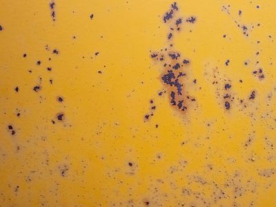 Blue fields meet the grey, heavy marks trace the surface, time wears the finish