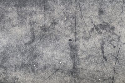 Blue fields meet the rust, orange veins bleed on the steel, grit holds the shoreline