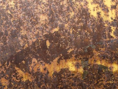 Orange scales erupt, yellow paint yields to the grit, time devours the steel