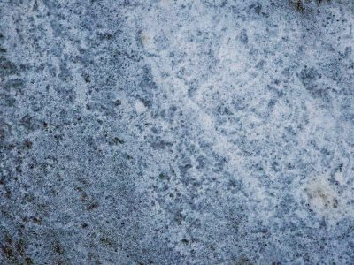 Blue fields turn to grey, mottled skin on the cold stone, ice traces the grit