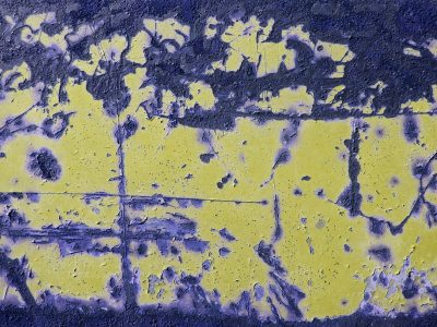 Blue fields turn to grey, orange rust spots mark the plate, grit holds the pattern