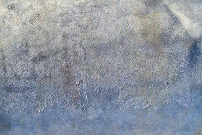 Blue islands remain, orange rust blooms on the steel, time wears the finish