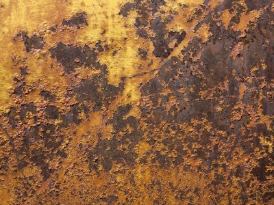 Blue layers peel back, orange mist on the skin, grit marks the shoreline