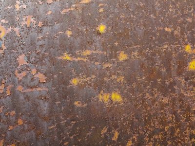 Iron turns to dust, yellow paint hides in the pits, metal wears away