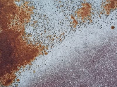 Blue paint flakes away, orange rust claims the cold steel, time wears down the coat