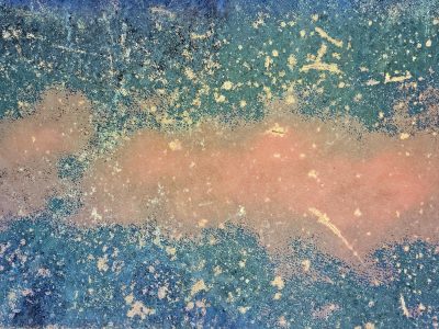 Blue paint holds the edge, orange rust blooms on the steel, grit marks the finish