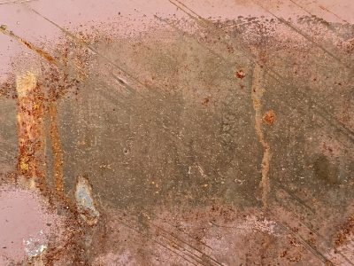 Blue paint holds the edge, orange rust eats the cold steel, grit marks the finish