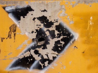 Blue paint holds the line, orange rust breaks the field, grit marks the finish