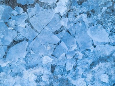 Blue shards divide, jagged frost traces the field, winter stays in the grain