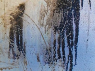 Blue skin flaking fast, jagged edges meet the light, grit marks the clear field