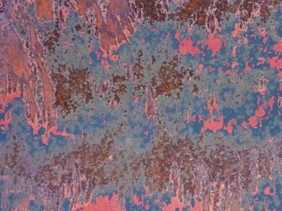 Blue skin has dark spots, vertical lines bleed through, grit marks the finish