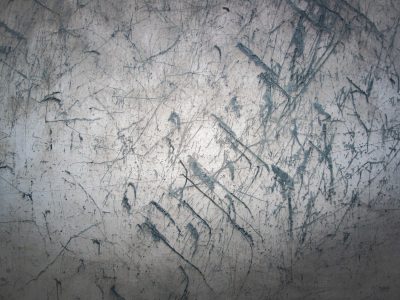 Blue skin has light marks, jagged lines trace the field, grit marks the finish