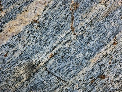 Blue veins in the rock, rust stains on the silver grain, grit holds the pattern