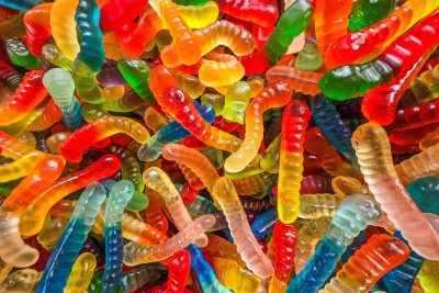 Bright curves twist in light, sugar grit holds the organic, sweet forms meet the glass