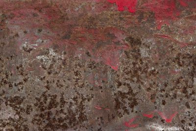 Red paint flakes away, oxidation claims the steel, iron turns to dust