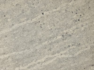 Cream skin pits and bumps, dark spots mark the fading paint, grit meets the shadow