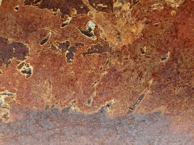 Burnt orange decay, iron skin peels from the frame, time leaves its red mark