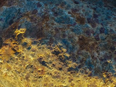 Grey skin has white streaks, jagged veins bleed through the field, light holds the pattern