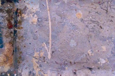 Grey skin turns to white, black spots bloom on pitted steel, grit holds the pattern