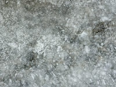 Frozen ground of ice, salt and grit mar the surface, winter holds its breath