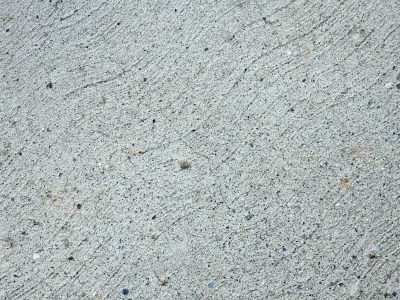 Grey stone spreads across, rough lines trace a path unseen, grit holds steady fast