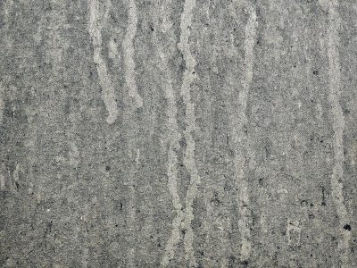 Grey streaks on the door, silver skin meets water trails, road grime leaves its mark.