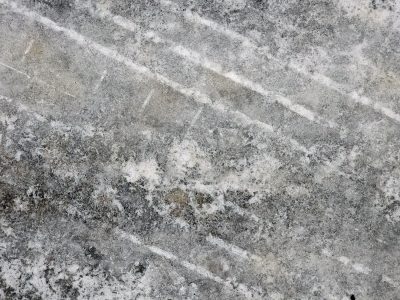 Grey streaks on the floor, white lines trace the fading path, grit meets the worn edge