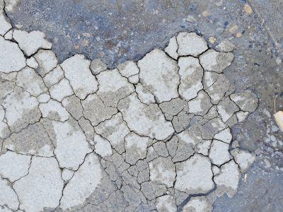 Jagged lines divide the grey, sharp edges meet the wet, grit marks the fracture