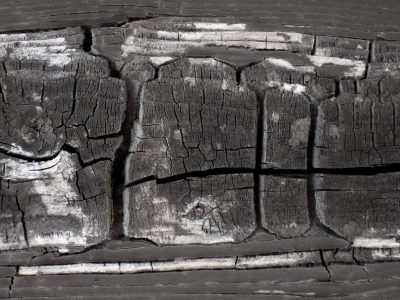Orange bricks meet white mortar, rough grid traces the wall, grit holds the masonry