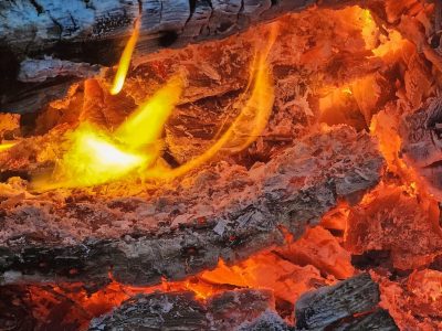 Orange glow deep down, red heat burns the heavy wood, ash holds the light now