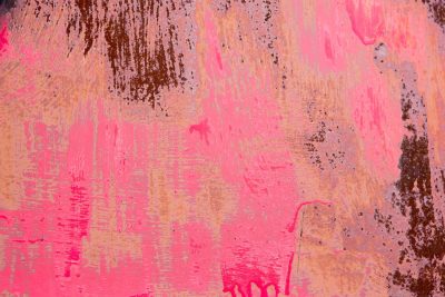 Bright pink starts to peel, rust bleeds through the vibrant skin, time claims the metal