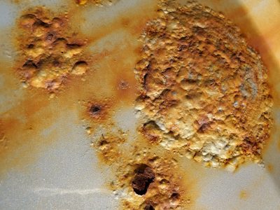 Orange veins in the grey, mineral traces mark the stone, grit holds the pattern