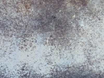 Faint white paint recedes, cracked and worn by passing time, rough stone breathes beneath