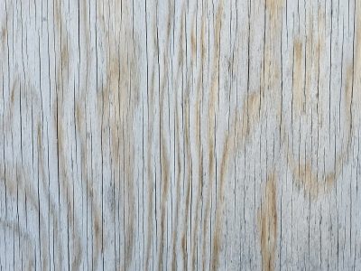 Pale wood shows the grain, vertical lines trace the board, time wears down the face
