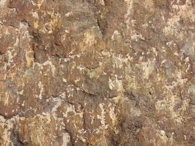 Pink granite grains, grey mineral veins trace the stone, grit holds the crystalline pattern