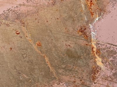 Pink paint meets the rust, orange veins bleed on the steel, time claims the finish