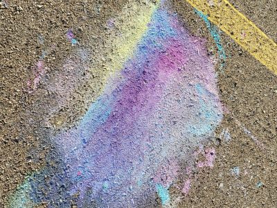 Purple dust on grey, yellow lines trace the heavy road, chalk meets the surface