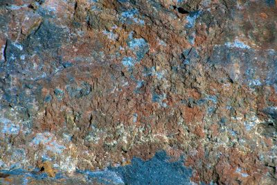 Red fields meet the blue, heavy grains crust on the skin, mineral flows fast