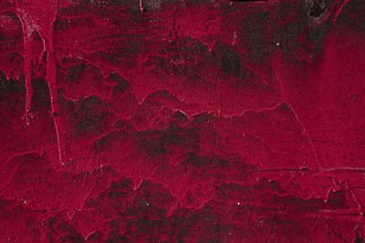 Crimson paint descends, dark iron stained deep with red, marks of heavy time