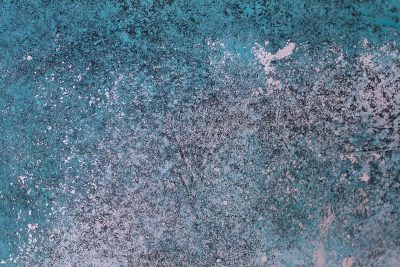 Teal paint fades away, silver flecks break through the skin, time wears down the wall