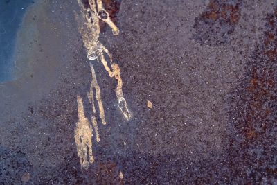 Red skin peels away, orange rust takes the heavy steel, earth returns to grit