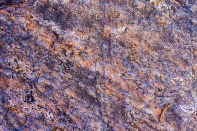 Rough pits scar the blue, orange rust meets the grey skin, time wears the pattern