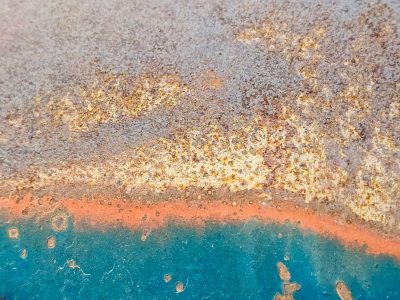 Rough scales of oxide, Teal yields to the orange bloom, Iron turns to dust.