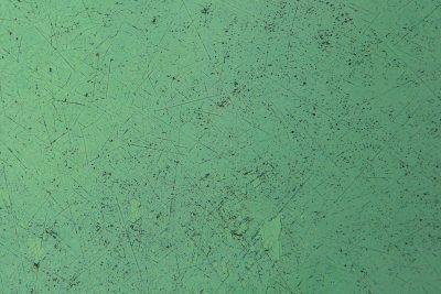 Rust spots on the blue, orange circles on the skin, grit meets the shadow