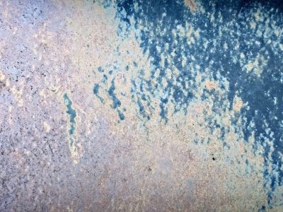 Blue frost meets the rust, mottled metal skin decays, age paints on the steel