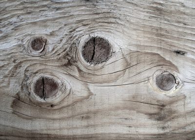 Silver grain flows fast, vertical lines trace the board, time wears the finish