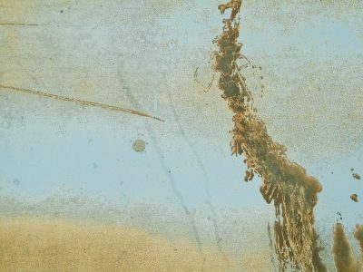 Blue paint wears away, brown stains drip down the cold steel, scratches mark the years