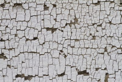 Silver wood holds the grain, vertical lines trace the board, time wears the finish