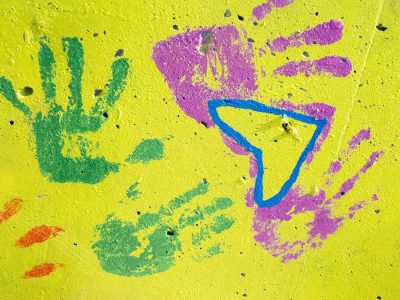 Painted hands remain, yellow stone holds every palm, color meets the rough